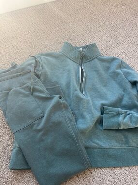 Travis Mathew women Zip-Up Sweater Set in Teal set with leggings